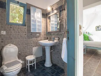 a bathroom with a toilet and a sink at Villa Clio with Pool Stalos Crete in Stalos