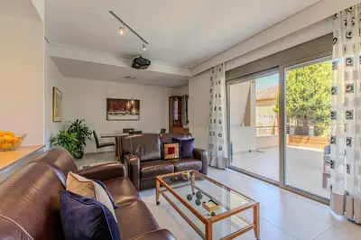 a living room with leather furniture and a glass table at Conte Marino Apartment in Chania Town