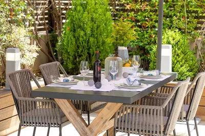 a table with chairs and a bottle of wine at Conte Marino Apartment in Chania Town