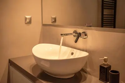 a white sink in a bathroom with a faucet at VenMar luxury house in Plataniás