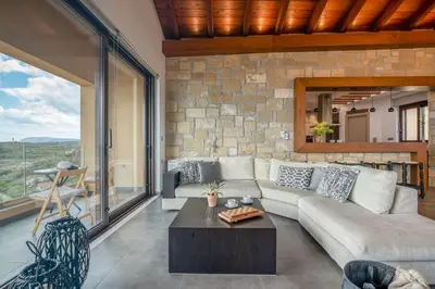 a living room with a couch and a table at VenMar luxury house in Plataniás