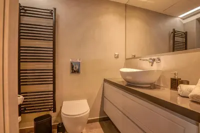 a bathroom with a white sink and a toilet at VenMar luxury house in Plataniás