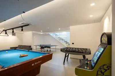 a living room with a pool table and a arcade game at Avery Villa in Chania Town