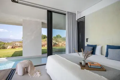 a bedroom with a white bed and a large window at Avery Villa in Chania Town