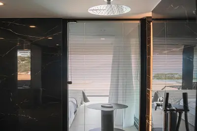 a glass door leading into a room with a table at Avery Villa in Chania Town