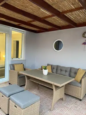 a patio with a table and chairs and a couch at Be Crete - Zen Appartments 1 room in Agia Marina Nea Kydonias