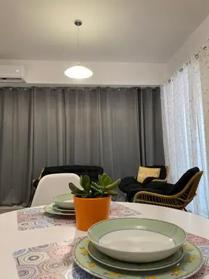 a dining room table with plates and a plant on it at Be Crete - Zen Appartments 1 room in Agia Marina Nea Kydonias