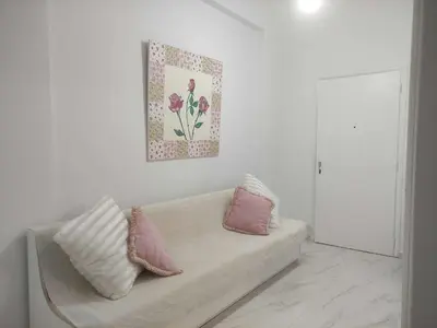 a living room with a couch with pillows on it at Teos App in Chania Town