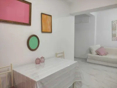 a white room with a table and a couch at Teos App in Chania Town