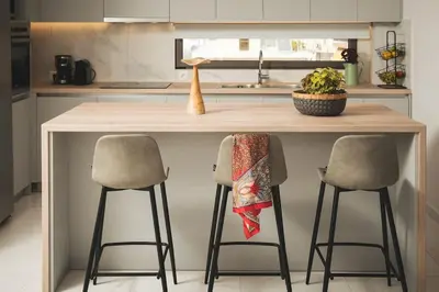 a kitchen with a counter with two bar stools at Afrodite-Μεζονέτα στην πόλη Χανιά in Chania Town