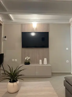 a living room with a flat screen tv on a wall at Foumidon Apartments, Chania in Chania Town