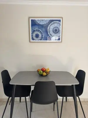 a table with chairs and a bowl of fruit on it at Foumidon Apartments, Chania in Chania Town