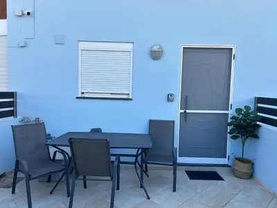 a blue room with a table and a door at Foumidon Apartments, Chania in Chania Town