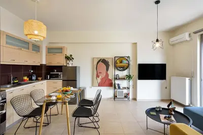 a kitchen and living room with a table and chairs at Ionia Cozy Home in Chania Town