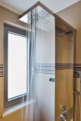 a shower with a window and a shower curtain at Ionia Cozy Home in Chania Town