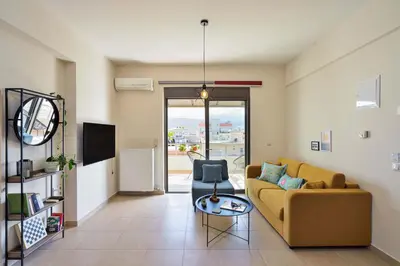 a living room with a couch and a table at Ionia Cozy Home in Chania Town
