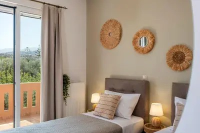 a bedroom with a bed and two mirrors on the wall at Armeria Apartments I I in Daratso