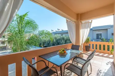 a balcony with a table and chairs with a view at Armeria Apartments I I in Daratso