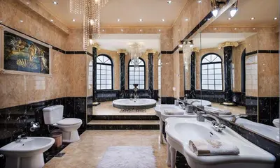 a bathroom with three sinks and two toilets at Pandis Palace in Agios Onoufrios