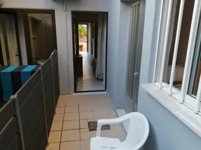 a white chair sitting in a hallway next to a window at Ελευθέριος, rooms 1 in Chania Town