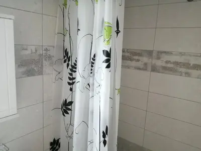 a shower curtain with plants on it in a bathroom at Ελευθέριος, rooms 1 in Chania Town