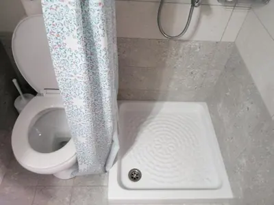 a bathroom with a toilet with a shower curtain at Ελευθέριος rooms 2 in Chania Town
