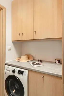a kitchen with a washing machine on a counter at Orange Seaside Apartment in Galatás