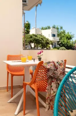 a table and two chairs and a table and chairs at Orange Seaside Apartment in Galatás