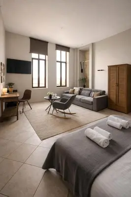 a living room with two beds and a couch at Endless blue suites 3 in Chania Town