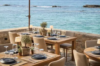 a table set up for a meal with the ocean in the background at Endless blue suites 3 in Chania Town