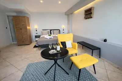 a hotel room with a bed and a table and chairs at Endless blue suites 4 in Chania Town