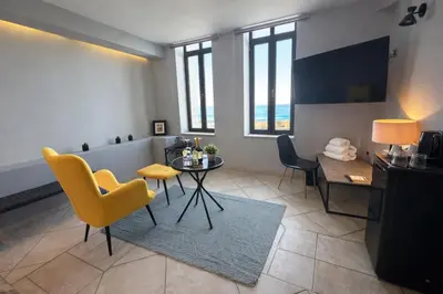 a living room with a yellow chair and a table at Endless blue suites 4 in Chania Town