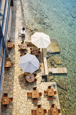 an overhead view of tables and umbrellas on the beach at Endless blue suites 4 in Chania Town