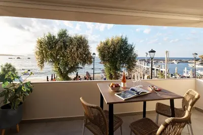 a dining room with a table and a view of the ocean at Callista Seafront Studio in Chania Town