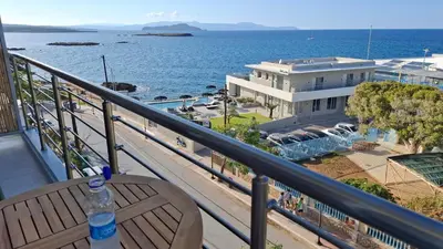 a bottle of water sitting on a table on a balcony at Sea View Modern 2BR Top Floor on Nea Chora Beach in Chania Town