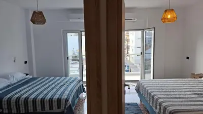 a bedroom with a bed and a view of a city at Sea View Modern 2BR Top Floor on Nea Chora Beach in Chania Town