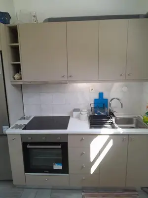 a kitchen with a sink and a stove top oven at Erofili Apartment in Kalyves