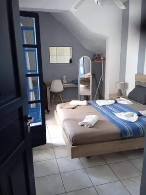 a bedroom with a bed and a desk in a room at Erofili Apartment in Kalyves