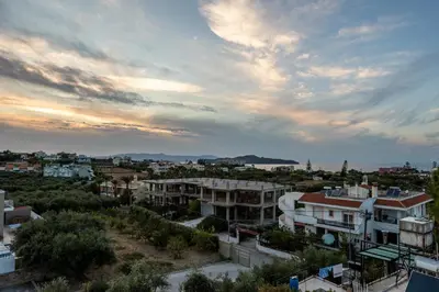 a view of a city at sunset at 2 bd sea view sun terrace apartment 500 meters walk to the beach in Galatás
