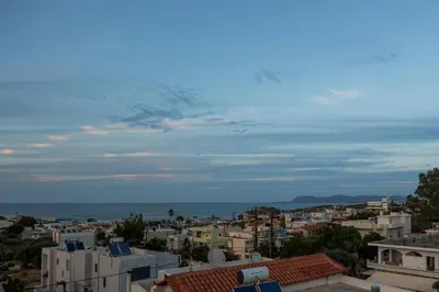 a view of a city with buildings and the ocean at 2 bd sea view sun terrace apartment 500 meters walk to the beach in Galatás
