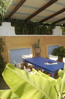 a patio with a blue table and chairs at Proimos Apartments in Gerani Chanion