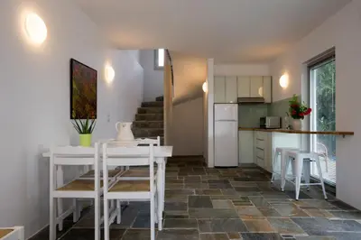 a kitchen and dining room with a table and chairs at Proimos Apartments in Gerani Chanion