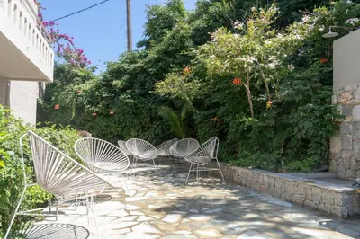 a group of chairs sitting on a patio at Hotel Agapi Apartments in Plataniás