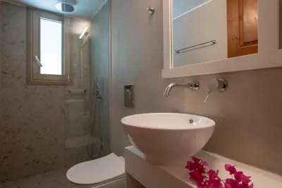 a bathroom with a sink and a toilet and a shower at Hotel Agapi Apartments in Plataniás