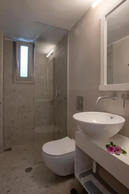 a bathroom with a toilet and a sink and a shower at Hotel Agapi Apartments in Plataniás