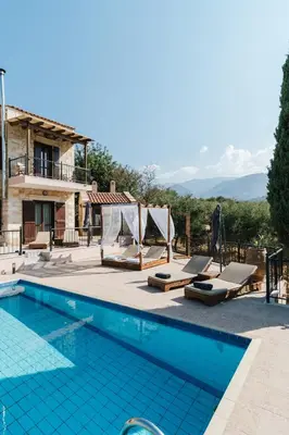 a villa with a swimming pool and a house at Villa Elia Provarma - Your villa in Chania Town