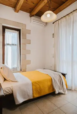 a bedroom with a bed and a large window at Villa Elia Provarma - Your villa in Chania Town