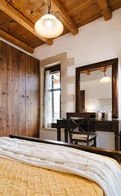 a bedroom with a bed with a mirror and a desk at Villa Elia Provarma - Your villa in Chania Town