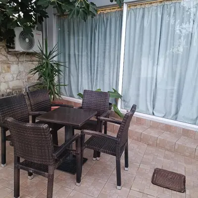 a patio with a table and chairs and a window at Drosoula house in Chania Town
