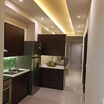 a kitchen with a refrigerator and a sink in a room at Drosoula house in Chania Town